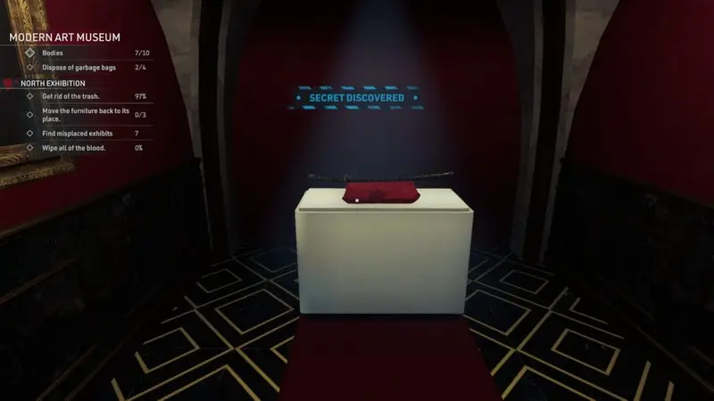 A black katana rests upon a red pillow on a display.