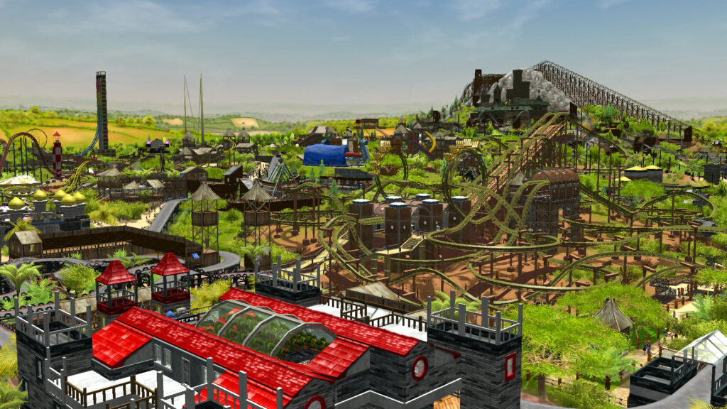 A theme park with various rides including several rollercoasters sprawls out across the land from the foreground.